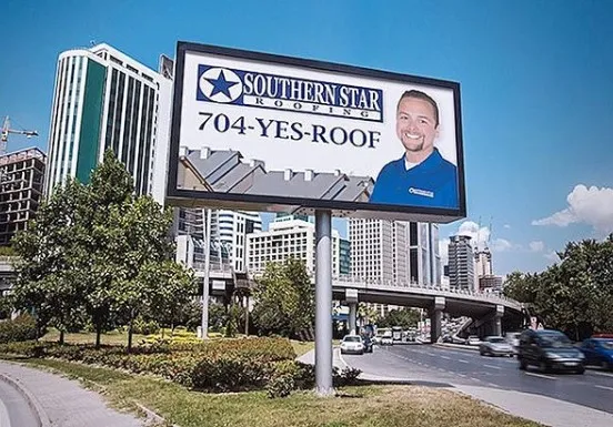 Southern Star Roofing city billboard in Uptown Charlotte — call 704-YES-ROOF for new roof or roof repair