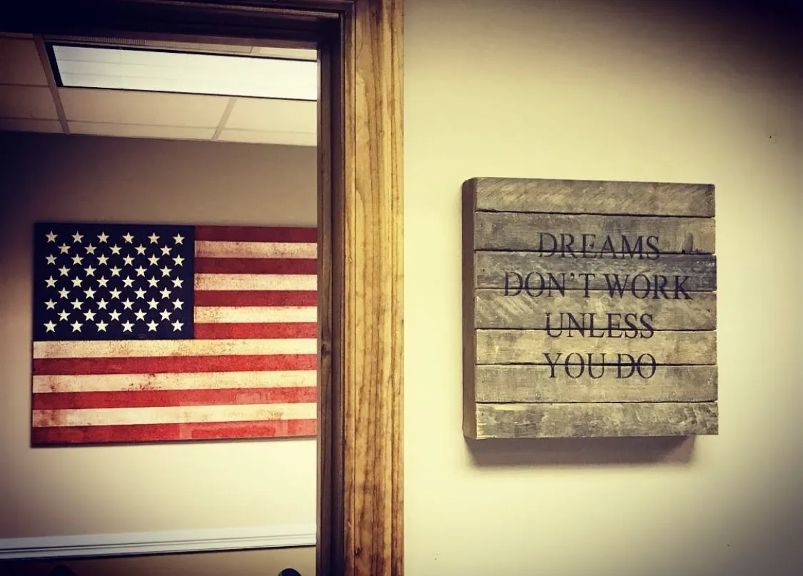 Southern Star Roofing office — American flag and Dreams Don't Work Unless You Do values sign